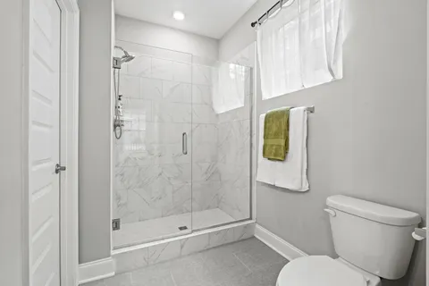 a bathroom with a shower and toilet