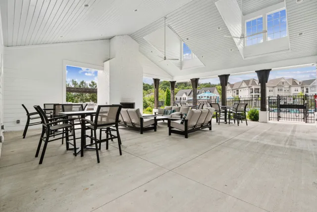 a view of a livingroom with furniture and floor to ceiling window
