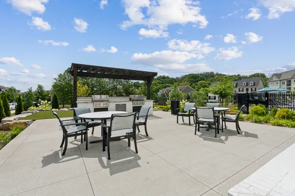 a view of a patio with dining table and chairs with a patio