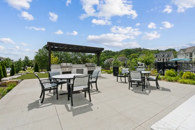 a view of a patio with dining table and chairs with a patio