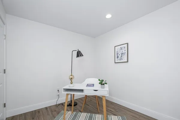 a view of a workspace with furniture and wooden floor
