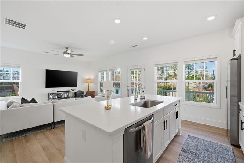 3158 Webb Road Milton, GA 30004 - Photo 12 of 36 a living room with stainless steel appliances furniture and a flat screen tv
