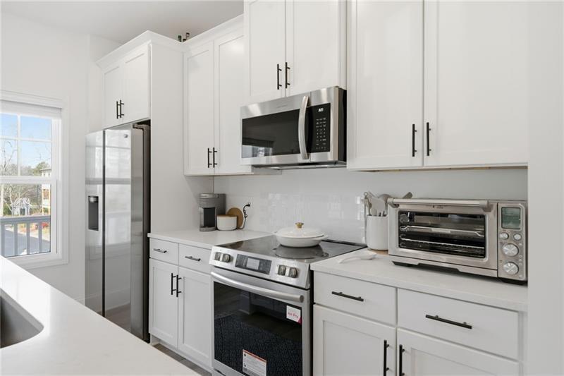3158 Webb Road Milton, GA 30004 - Photo 13 of 36 a kitchen with stainless steel appliances white cabinets and a stove