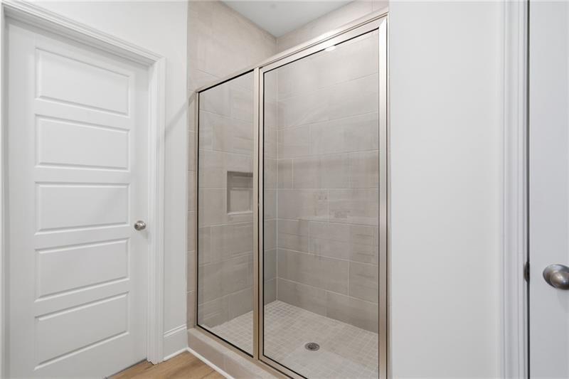 3158 Webb Road Milton, GA 30004 - Photo 21 of 36 a bathroom with a glass shower door