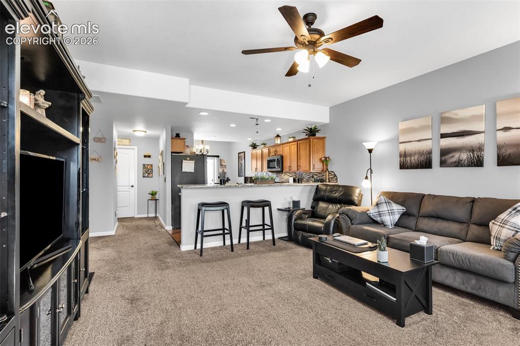 415 Empire Road Canon City, CO 81212 - Photo 8 of 40 a living room with furniture a ceiling fan and a flat screen tv