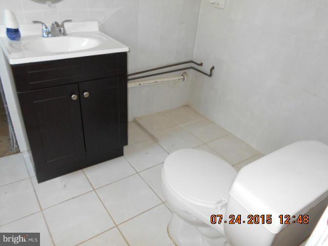 4112 Belt Road Capitol Heights, MD 20743 - Photo 11 of 13 a bathroom with a sink and a mirror