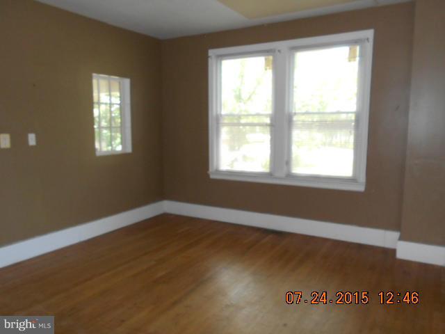 4112 Belt Road Capitol Heights, MD 20743 - Photo 4 of 13 a view of an empty room with wooden floor and a window