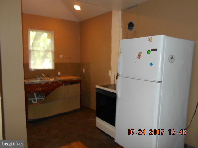 4112 Belt Road Capitol Heights, MD 20743 - Photo 5 of 13 a white refrigerator freezer sitting in a kitchen
