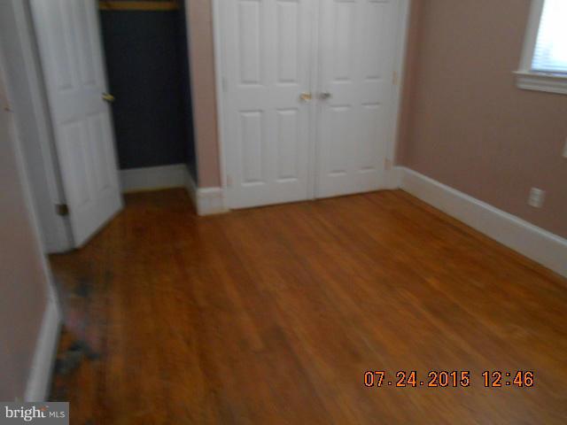 4112 Belt Road Capitol Heights, MD 20743 - Photo 6 of 13 an empty room with wooden floor