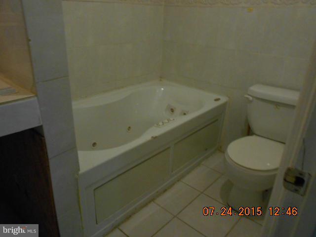 4112 Belt Road Capitol Heights, MD 20743 - Photo 7 of 13 a bathroom with a toilet and a bathtub