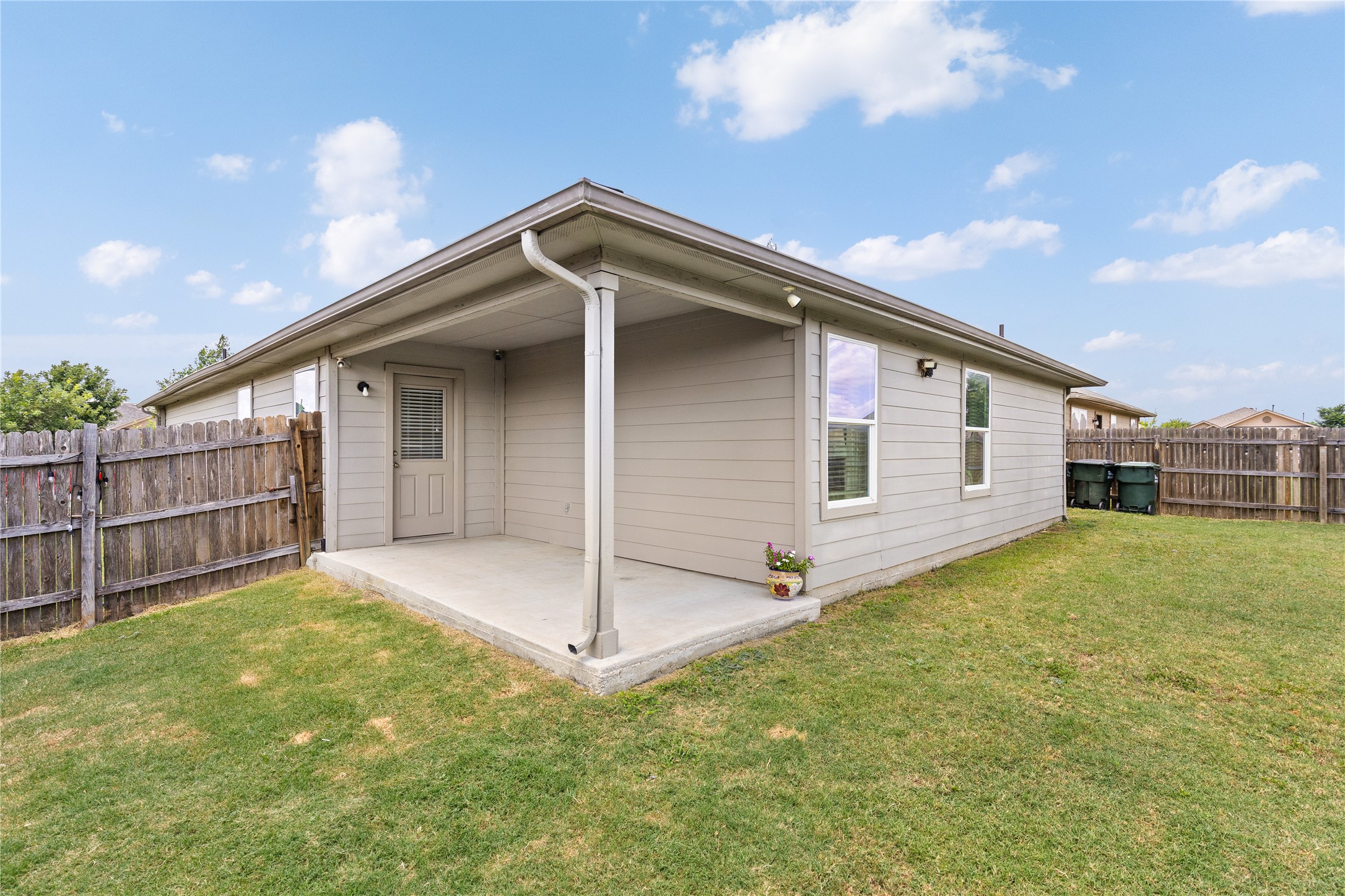256 Alpha Kyle, TX 78640 - Photo 23 of 27 A spacious backyard with a private covered patio offers an ideal setting for outdoor enjoyment.