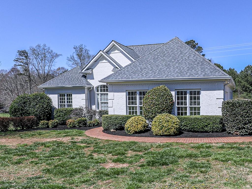 a front view of a house with a garden
