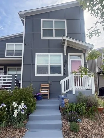a front view of a house with a garden