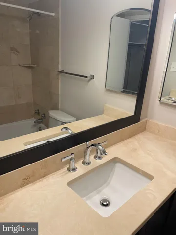 a white toilet sitting next to a shower