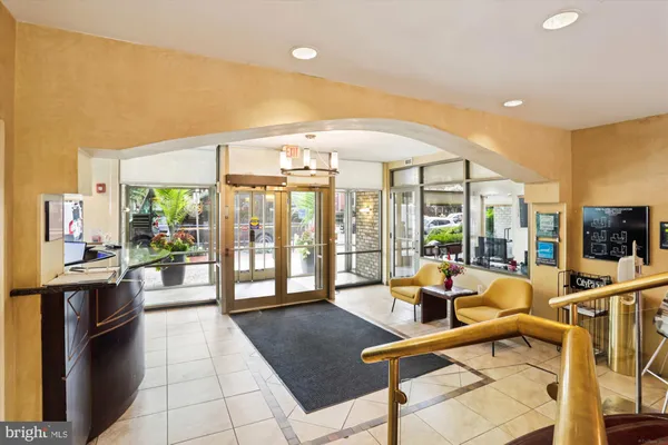 a lobby with furniture and floor to ceiling window