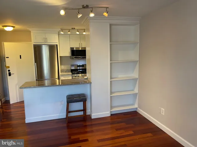 a kitchen with granite countertop a stove and a sink