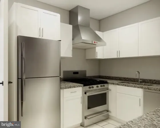 a kitchen with stainless steel appliances granite countertop a refrigerator a stove and a sink