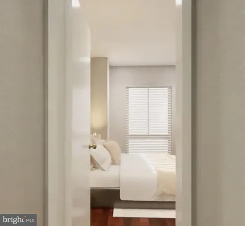 a bedroom with a white bed and wooden floor