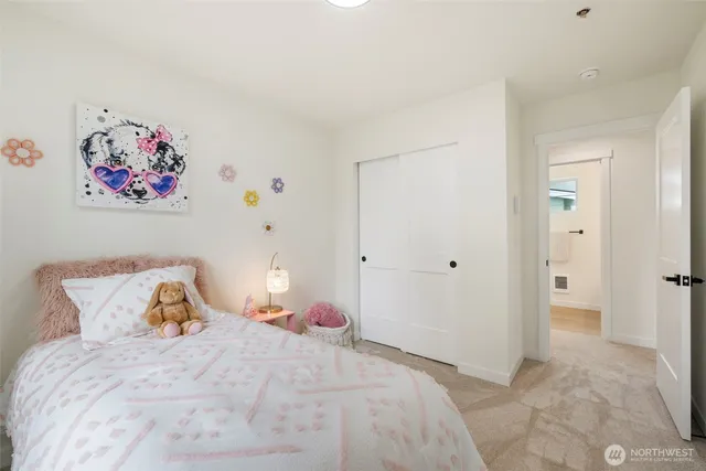 a bedroom with a bed and painting on the wall