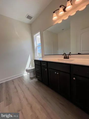 a kitchen with a sink and a mirror