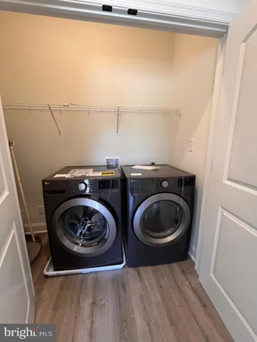 a utility room with sink dryer and washer