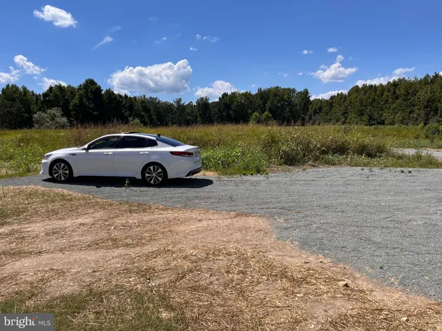 a view of a car in front of a lake with mountain view