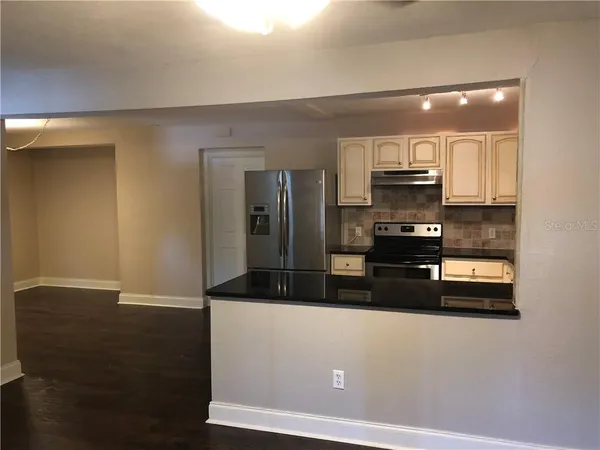 a kitchen with stainless steel appliances a refrigerator and a stove top oven