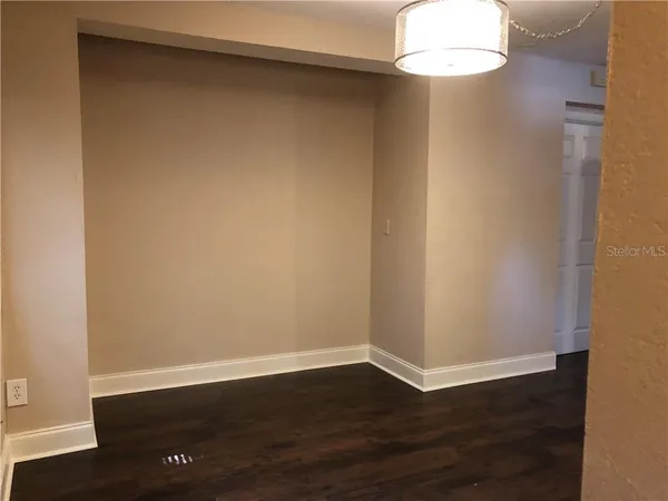 a view of a room with wooden floor