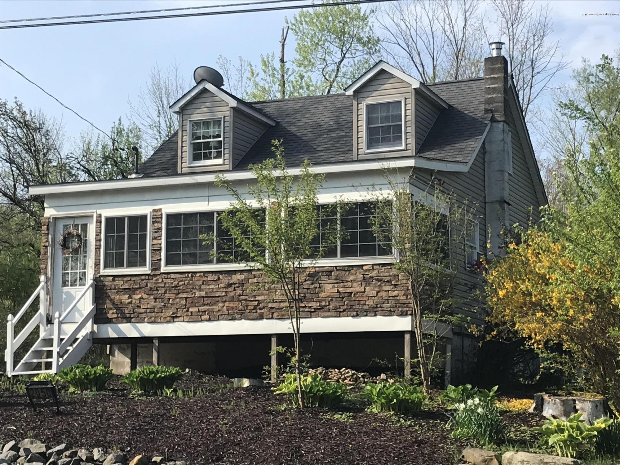 2050 Reservoir Road Moscow, PA 18444 - Photo 1 of 44 a view of house with a yard and potted plants