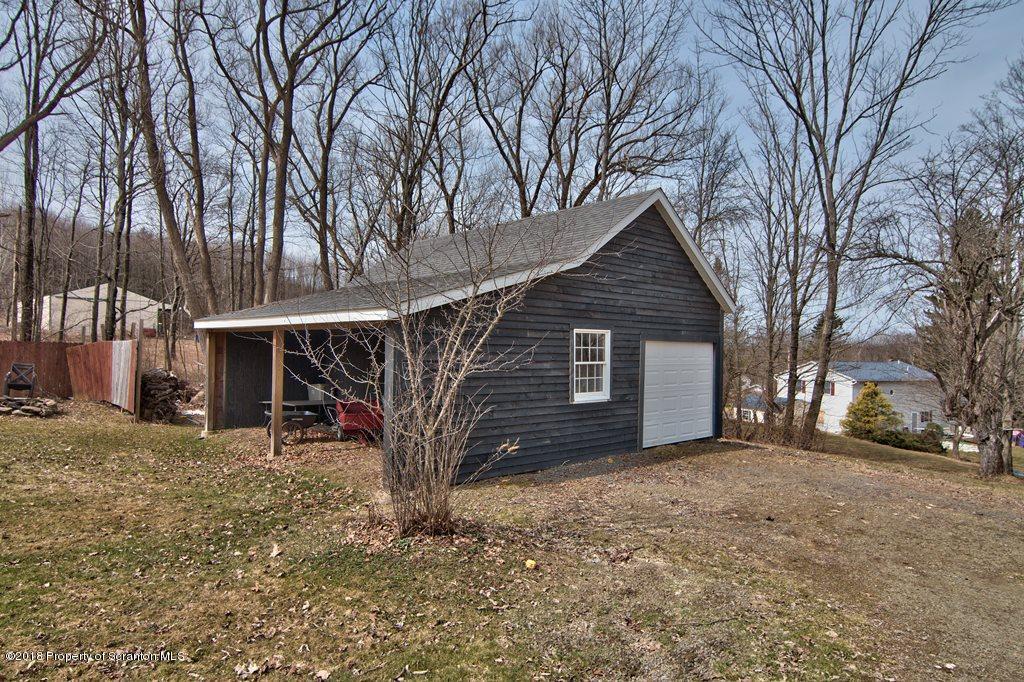 2050 Reservoir Road Moscow, PA 18444 - Photo 11 of 44 a view of a house with a yard and garage
