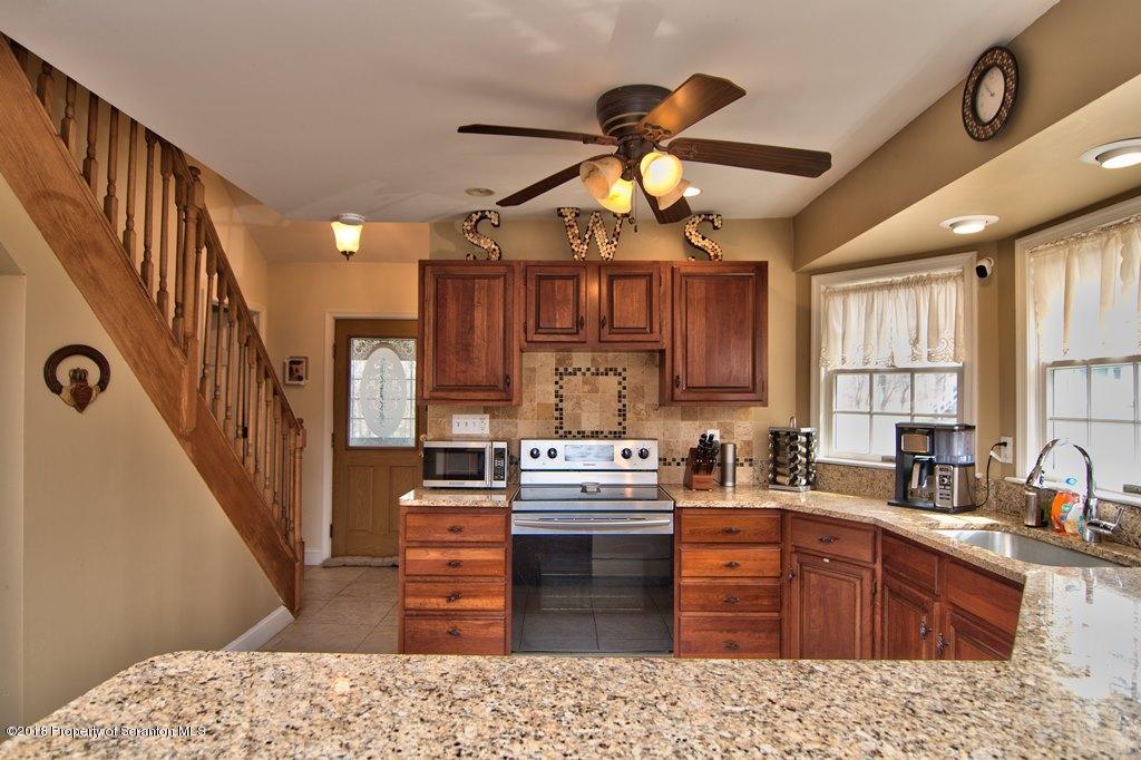 2050 Reservoir Road Moscow, PA 18444 - Photo 17 of 44 a kitchen with stainless steel appliances granite countertop a sink dishwasher stove and refrigerator