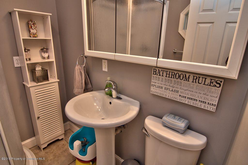 2050 Reservoir Road Moscow, PA 18444 - Photo 27 of 44 a bathroom with a sink a toilet and a mirror