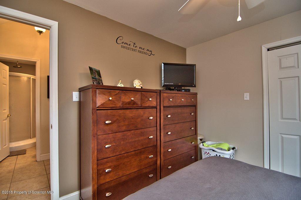2050 Reservoir Road Moscow, PA 18444 - Photo 30 of 44 a room with a bed and a television