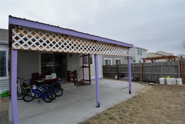 a view of a yard with wooden fence