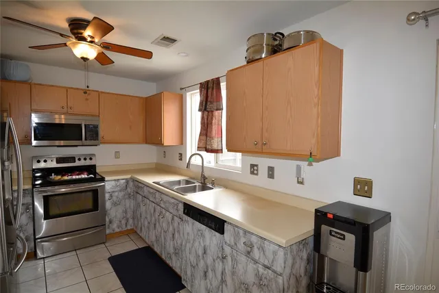 a kitchen with stainless steel appliances a refrigerator and a stove top oven