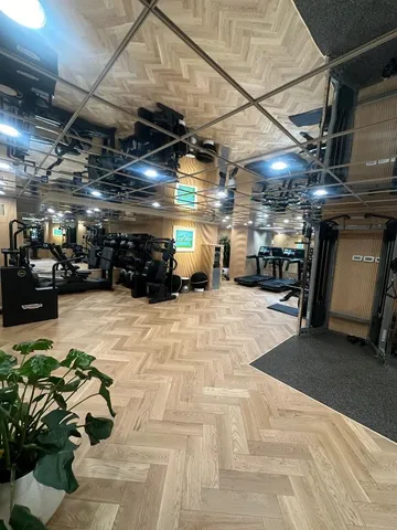 a spacious bathroom with a double vanity sink toilet and mirror