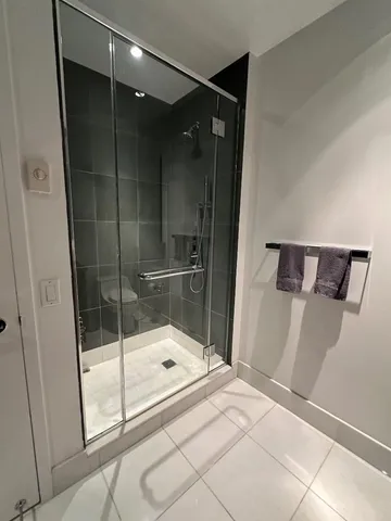 a bathroom with a bathtub sink and mirror
