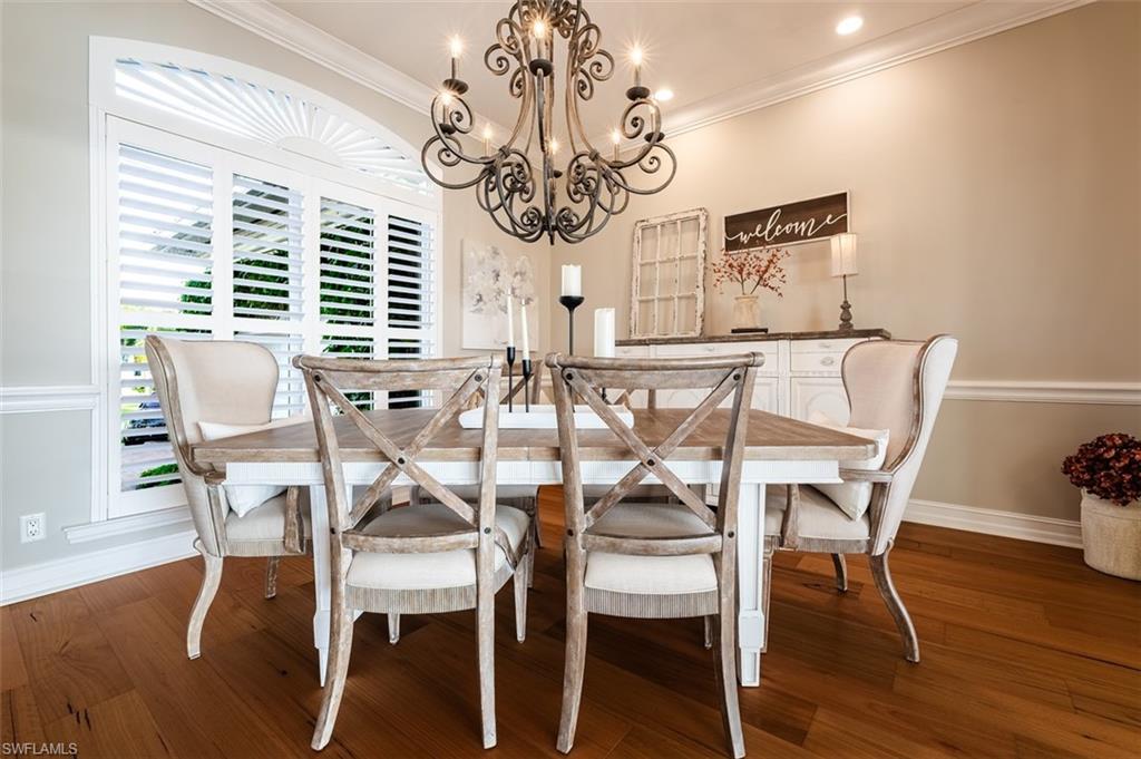 1942 Kingfish Road Naples, FL 34102 - Photo 21 of 43 a view of a dining room with furniture window and wooden floor