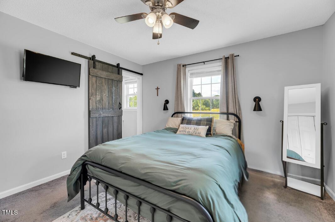 640 Short Journey Road Smithfield, NC 27577 - Photo 13 of 27 a bedroom with a bed and a flat screen tv