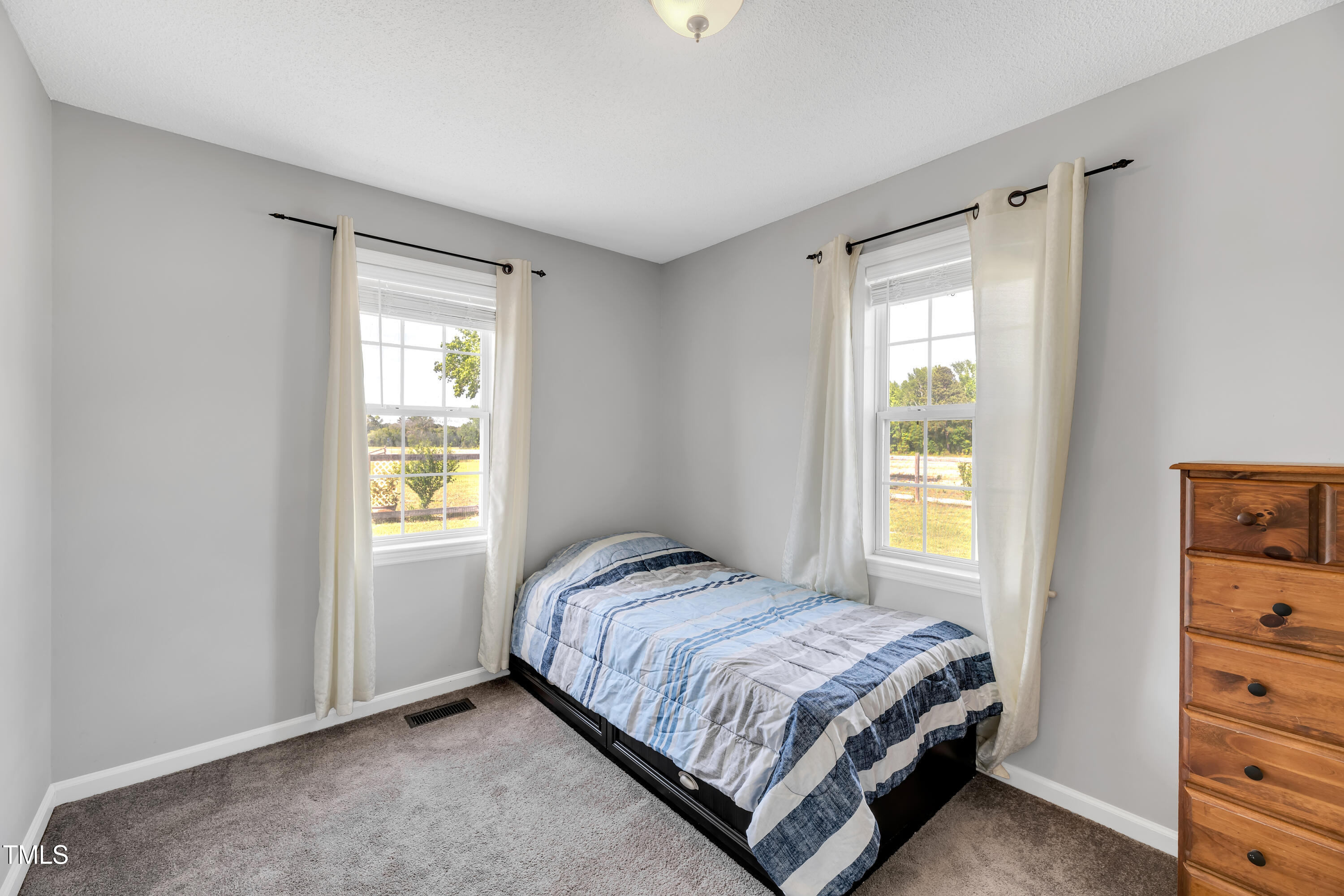 640 Short Journey Road Smithfield, NC 27577 - Photo 15 of 27 a bedroom with a bed and a window