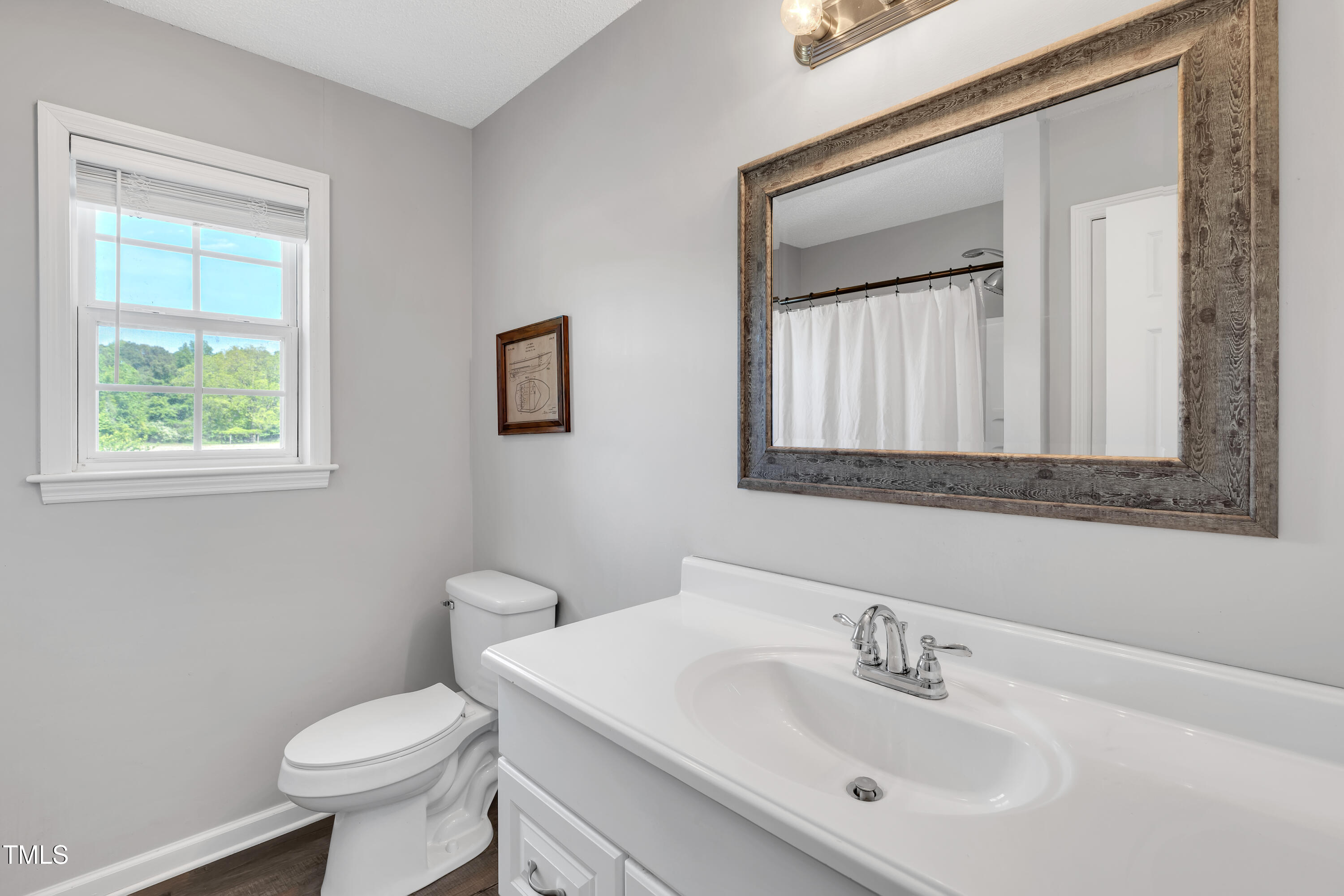 640 Short Journey Road Smithfield, NC 27577 - Photo 16 of 27 a bathroom with a toilet sink vanity and mirror