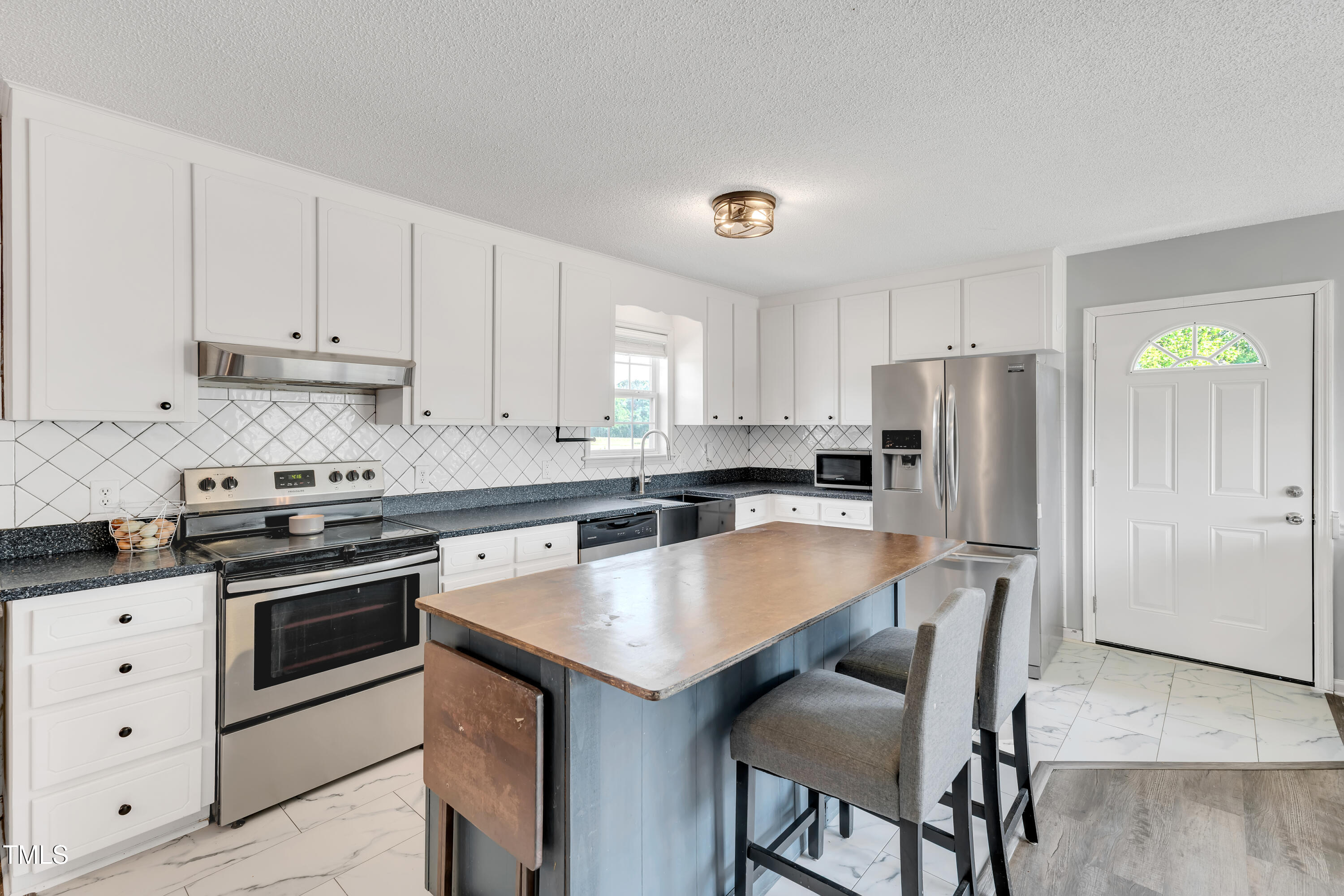 640 Short Journey Road Smithfield, NC 27577 - Photo 6 of 27 a kitchen with stainless steel appliances a stove a sink island and a refrigerator