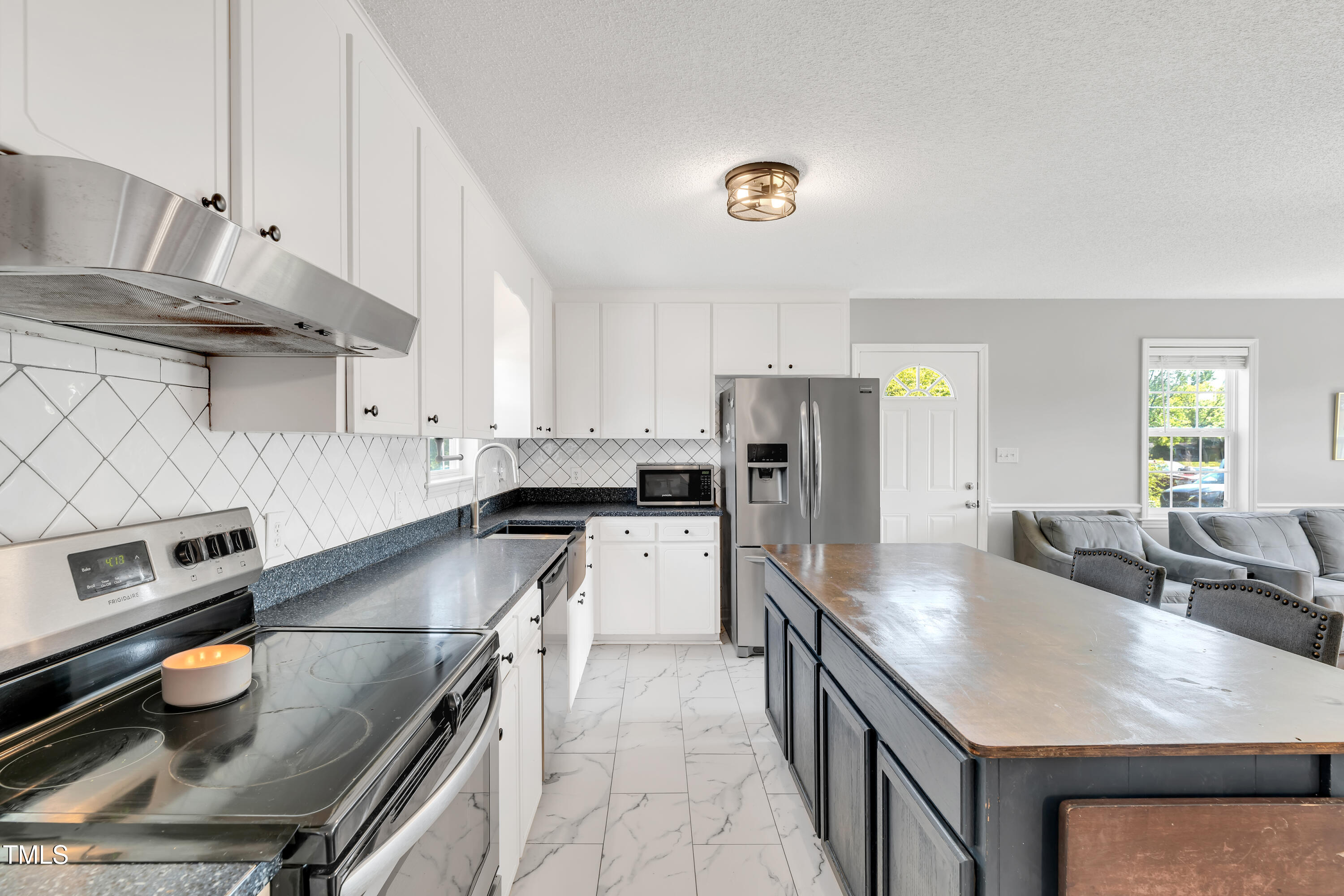 640 Short Journey Road Smithfield, NC 27577 - Photo 7 of 27 a kitchen with stainless steel appliances granite countertop a sink stove and refrigerator