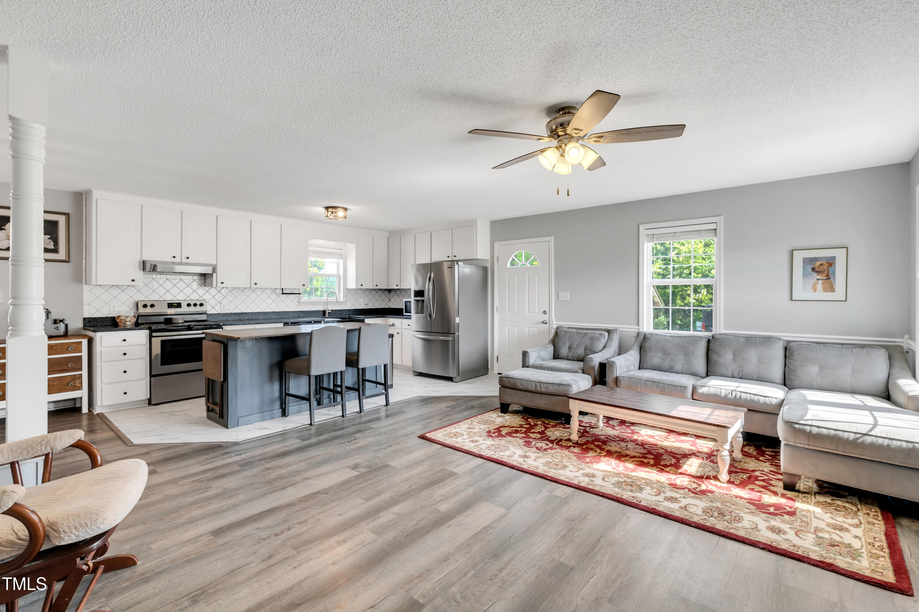 640 Short Journey Road Smithfield, NC 27577 - Photo 9 of 27 a living room with furniture kitchen view and a chandelier