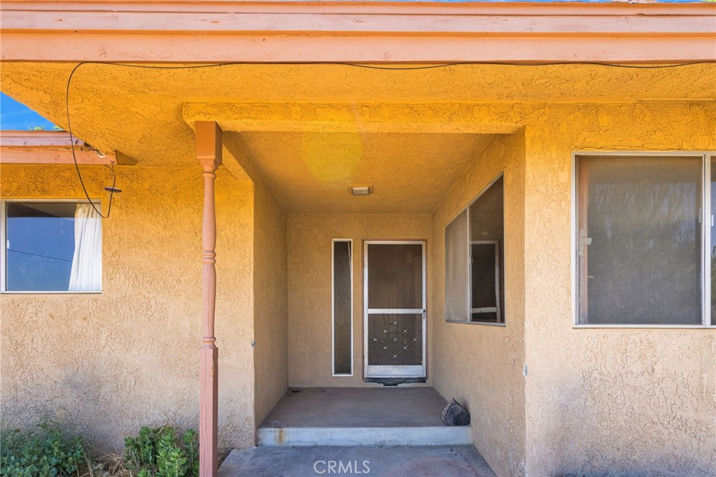 5500 Oil Well Road Phelan, CA 92371 - Photo 48 of 65 a view of a hallway with wooden floor and a glass door