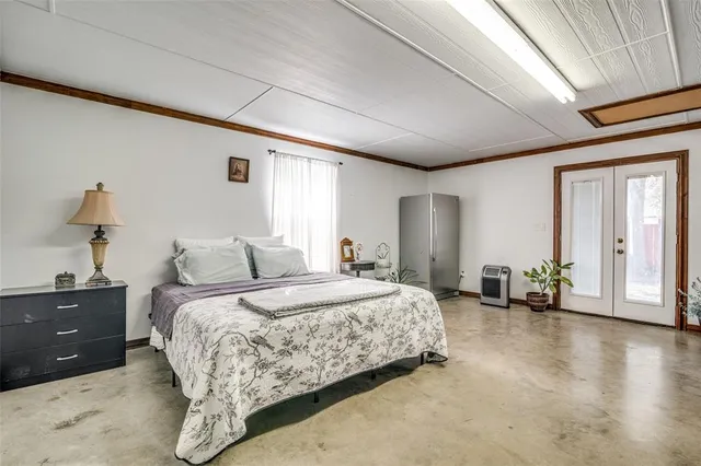 a spacious bedroom with a bed and a couch