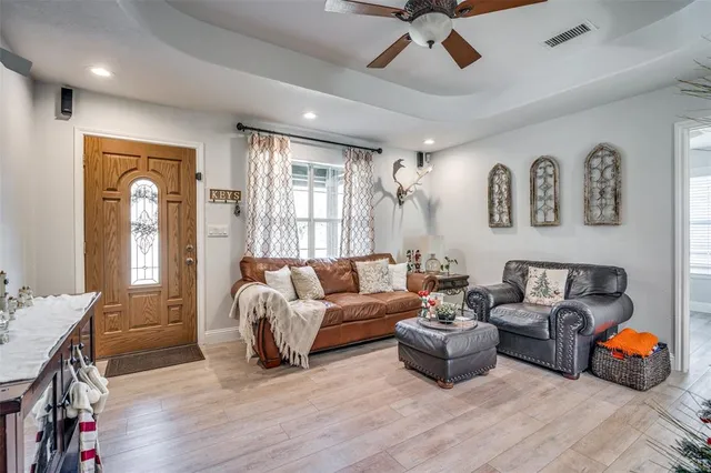 a living room with furniture and a wooden floor