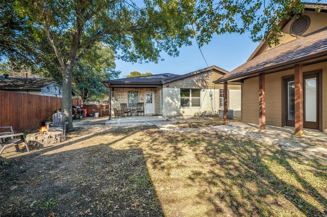 a front view of a house with a yard outdoor seating and garage