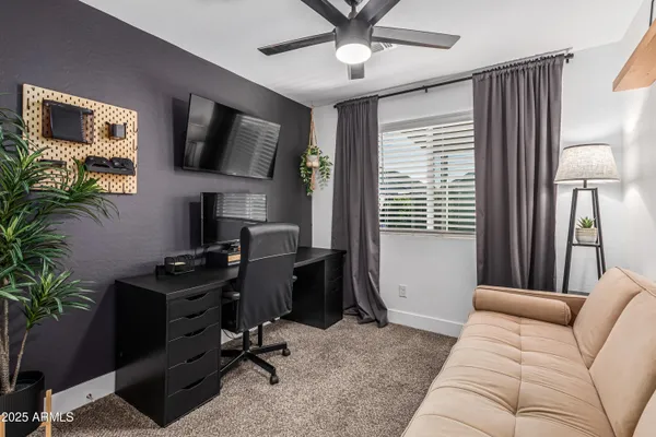 a livingroom with workspace and a window