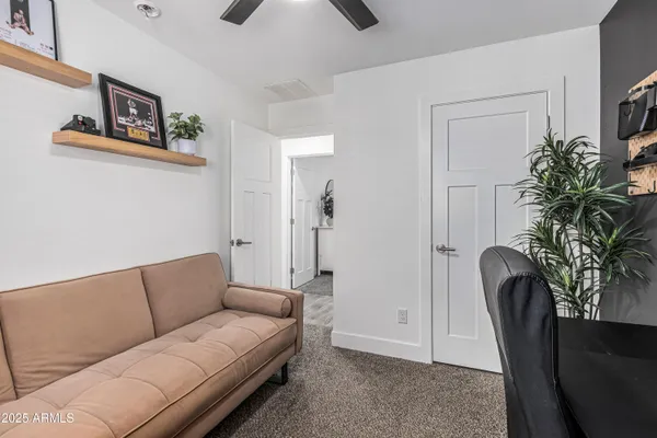 a living room with furniture and a potted plant